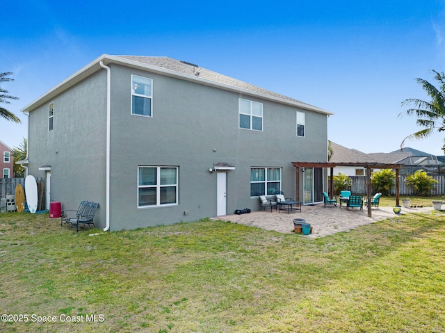 back of property featuring a lawn, a patio, stucco siding, and fence