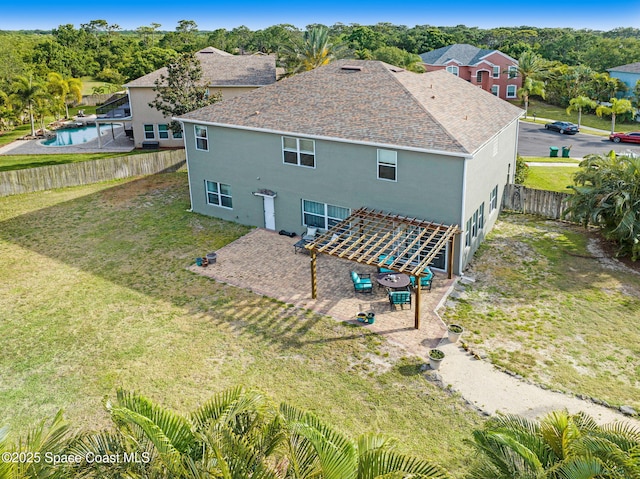 rear view of house featuring a fenced backyard, stucco siding, and a yard