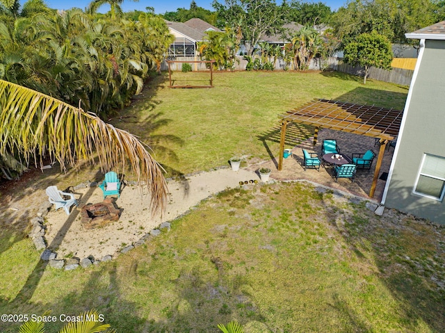 view of yard featuring fence, an outdoor fire pit, and a patio area