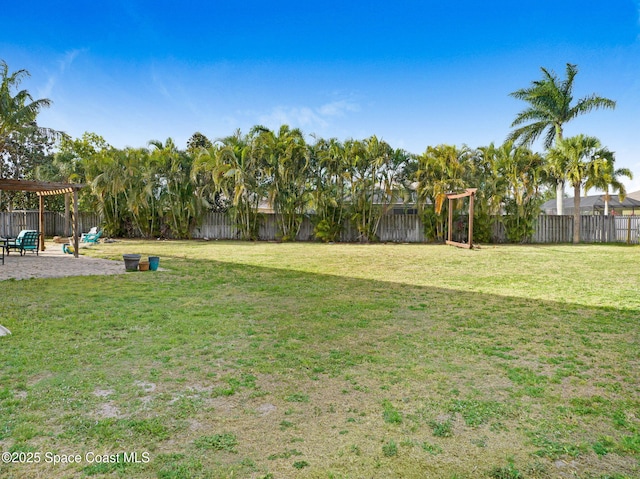 view of yard with a patio area, a pergola, and a fenced backyard
