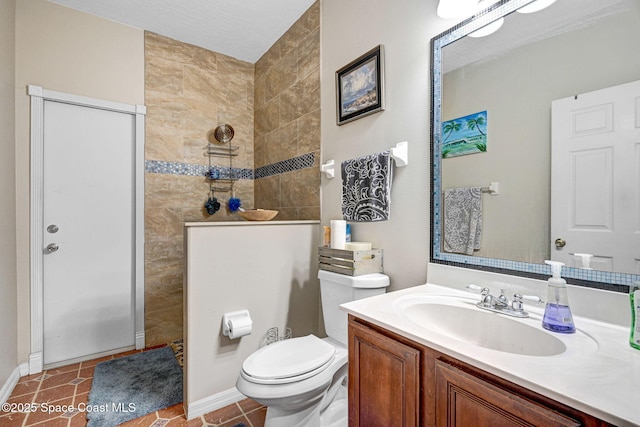 full bath featuring vanity, a walk in shower, toilet, baseboards, and tile patterned flooring