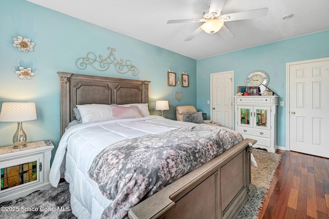 bedroom featuring a ceiling fan and dark wood finished floors