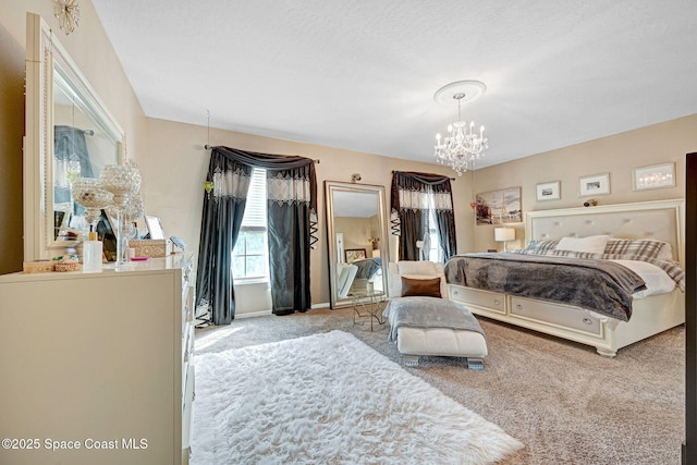 bedroom featuring baseboards, an inviting chandelier, and carpet floors