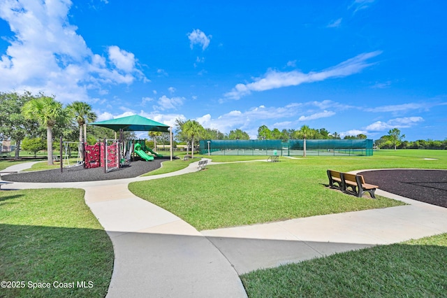view of home's community featuring playground community and a lawn