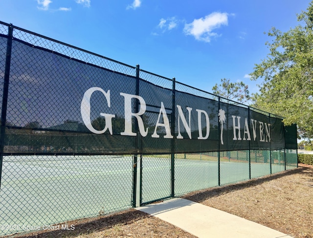 view of tennis court with fence