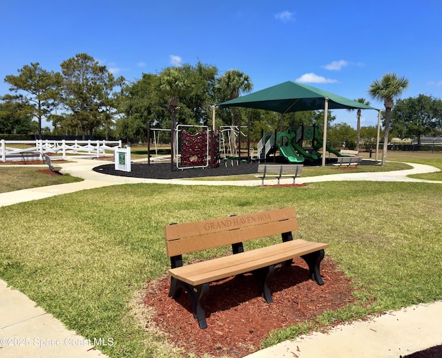 surrounding community featuring a lawn and playground community