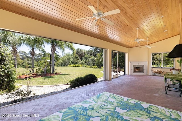 view of patio featuring a ceiling fan and exterior fireplace