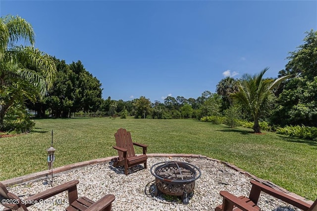 view of yard featuring a fire pit and a patio area