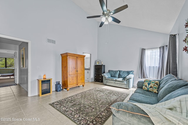 living area with high vaulted ceiling, ceiling fan, baseboards, and visible vents