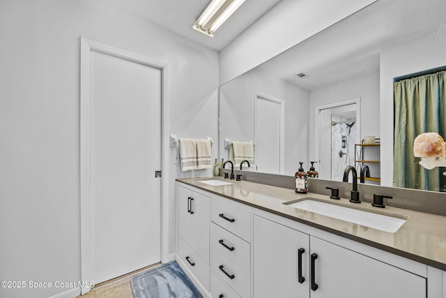 bathroom featuring double vanity, visible vents, and a sink
