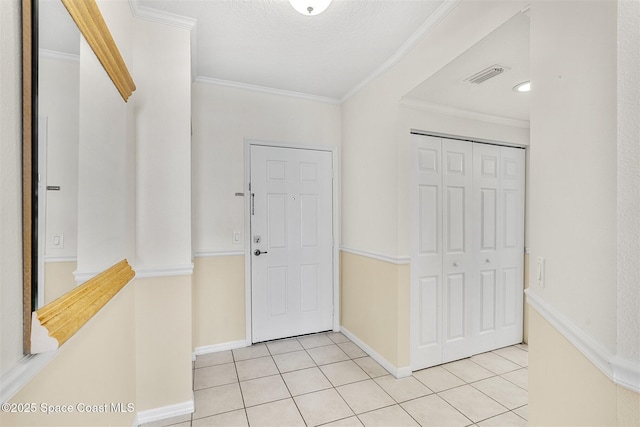 104 Riverside Dr Unit 402, Cocoa, FL 32922 - foyer entrance featuring baseboards, visible vents, ornamental molding, and light tile patterned floors