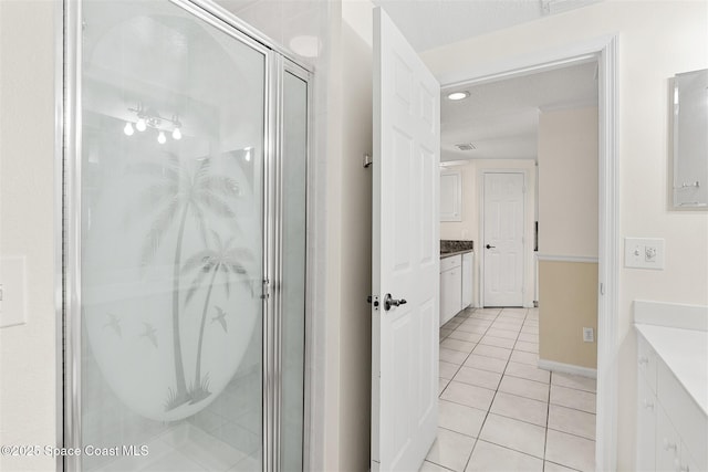 104 Riverside Dr Unit 402, Cocoa, FL 32922 - bathroom with vanity, a stall shower, baseboards, and tile patterned floors