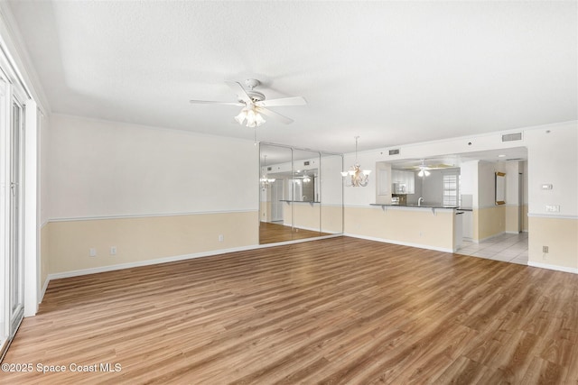 104 Riverside Dr Unit 402, Cocoa, FL 32922 - unfurnished living room with visible vents, a ceiling fan, baseboards, and light wood-type flooring