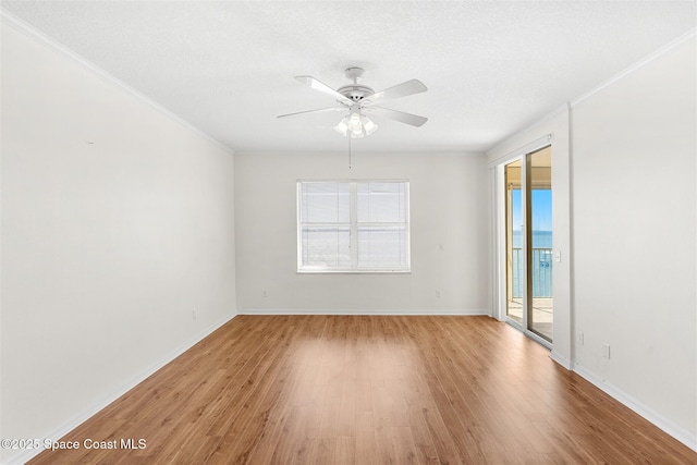 104 Riverside Dr Unit 402, Cocoa, FL 32922 - empty room with a ceiling fan, baseboards, ornamental molding, and light wood-style flooring