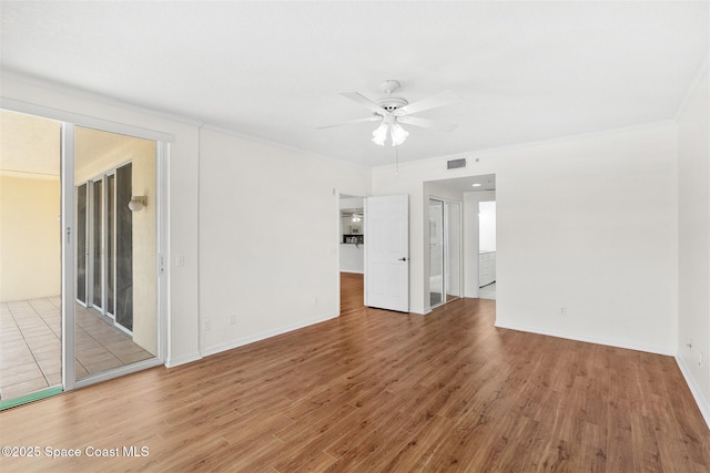 104 Riverside Dr Unit 402, Cocoa, FL 32922 - unfurnished room with visible vents, crown molding, wood finished floors, baseboards, and a ceiling fan