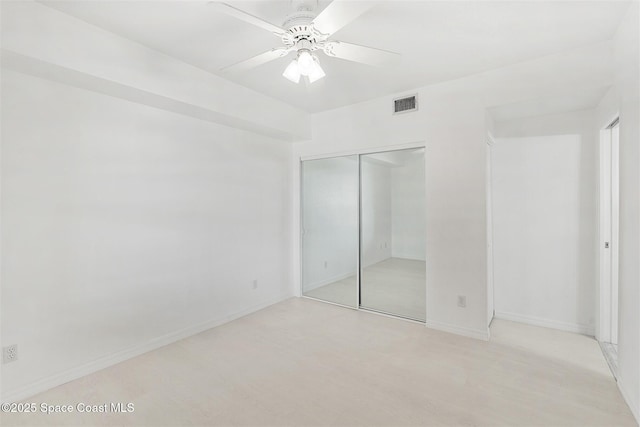 104 Riverside Dr Unit 402, Cocoa, FL 32922 - unfurnished bedroom with visible vents, a closet, baseboards, ceiling fan, and light wood-type flooring