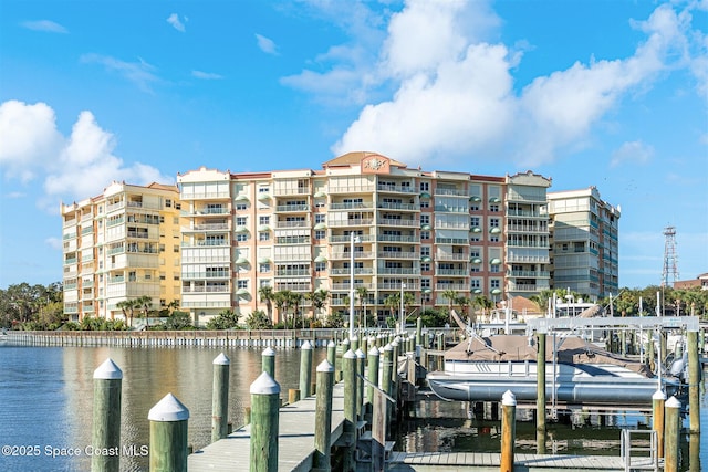 104 Riverside Dr Unit 402, Cocoa, FL 32922 - view of dock featuring boat lift and a water view