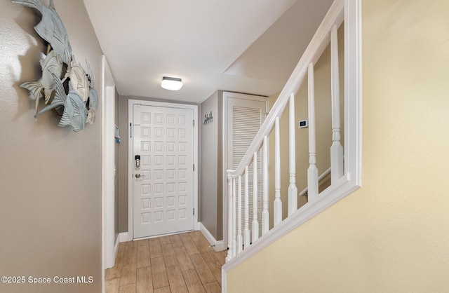 foyer featuring light wood-style floors and baseboards