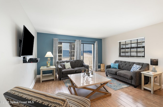 living room with hardwood / wood-style flooring and baseboards