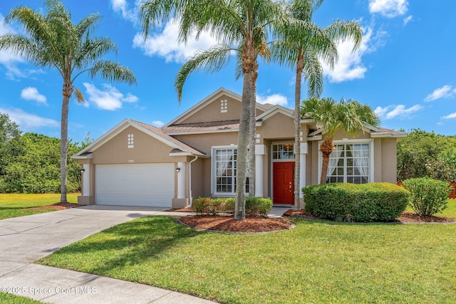 2100 Weatherly Ave, Melbourne, FL 32904 - single story home featuring stucco siding, an attached garage, driveway, and a front yard