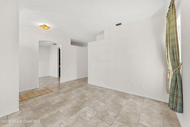2100 Weatherly Ave, Melbourne, FL 32904 - unfurnished room with arched walkways, baseboards, and visible vents