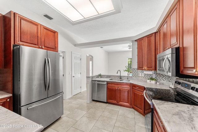 2100 Weatherly Ave, Melbourne, FL 32904 - kitchen with visible vents, arched walkways, a sink, backsplash, and stainless steel appliances