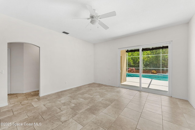 2100 Weatherly Ave, Melbourne, FL 32904 - empty room with visible vents, arched walkways, baseboards, and ceiling fan