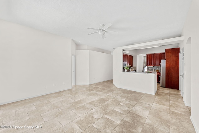 2100 Weatherly Ave, Melbourne, FL 32904 - unfurnished living room with a ceiling fan and baseboards
