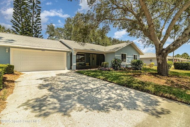 ranch-style house with an attached garage, stucco siding, driveway, and a front yard