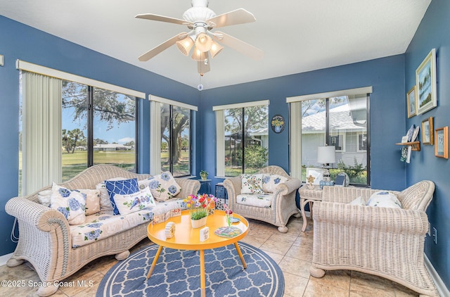 living area with a ceiling fan and tile patterned floors