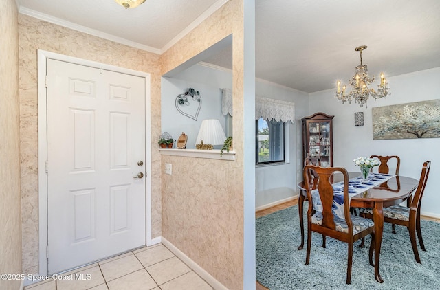dining room featuring crown molding, baseboards, and a notable chandelier