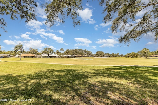 view of home's community featuring a yard and golf course view