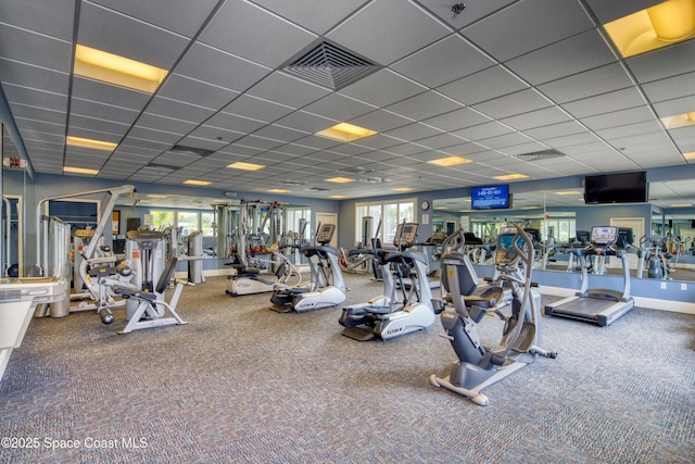 workout area with carpet flooring, visible vents, and a paneled ceiling