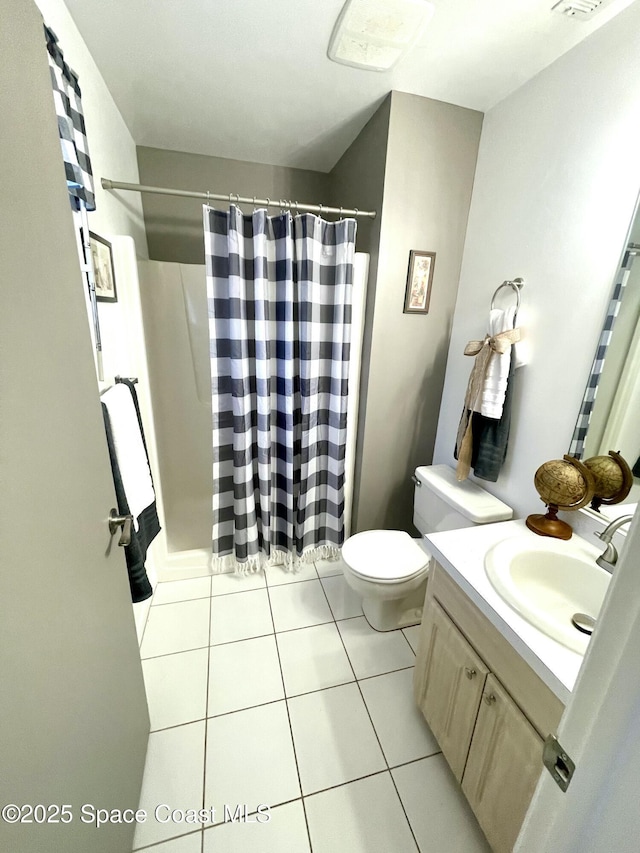 bathroom with tile patterned floors, a shower with curtain, toilet, and vanity