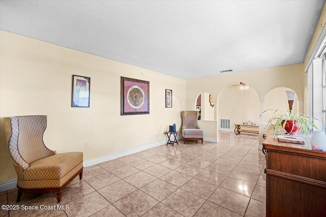 15 Skyline Blvd, Merritt Island, FL 32953 - living area with arched walkways, light tile patterned floors, and baseboards