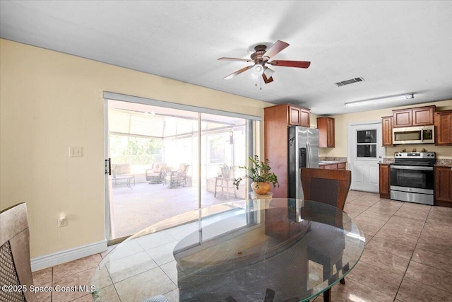 15 Skyline Blvd, Merritt Island, FL 32953 - dining space with a ceiling fan, light tile patterned floors, and baseboards