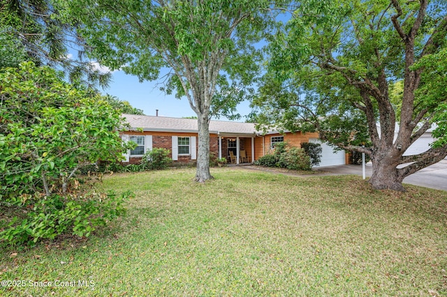 single story home featuring an attached garage, driveway, a front lawn, and brick siding