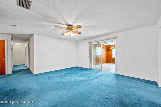 unfurnished room featuring ceiling fan, a textured ceiling, visible vents, baseboards, and carpet