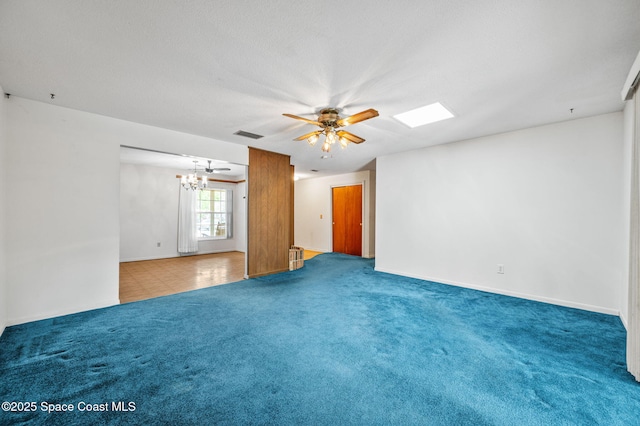 spare room with carpet flooring, baseboards, visible vents, and ceiling fan with notable chandelier
