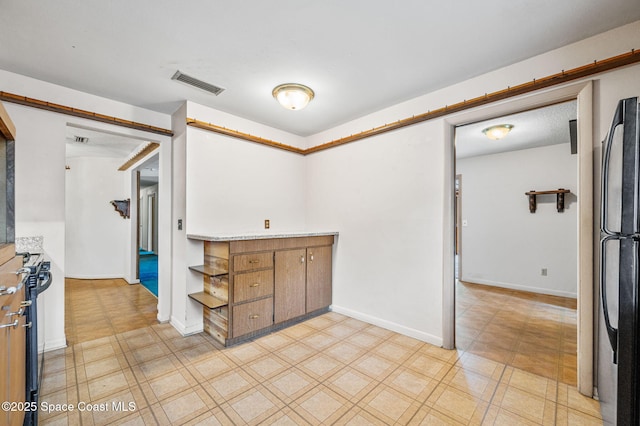 unfurnished room with visible vents and light floors