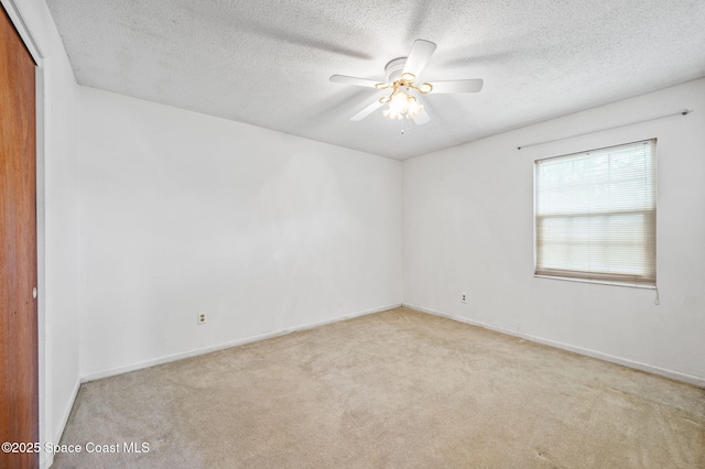 unfurnished room featuring carpet floors, a ceiling fan, a textured ceiling, and baseboards