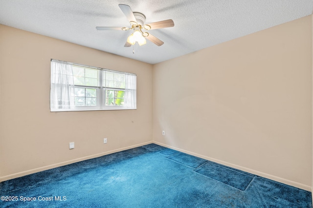 unfurnished room with baseboards, a ceiling fan, carpet flooring, and a textured ceiling