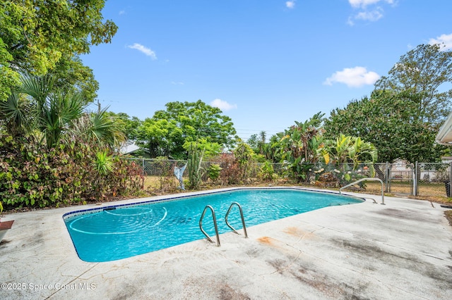 view of swimming pool featuring a fenced in pool, fence, and a patio