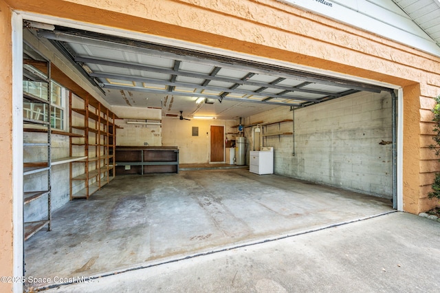 garage featuring water heater and washer / clothes dryer