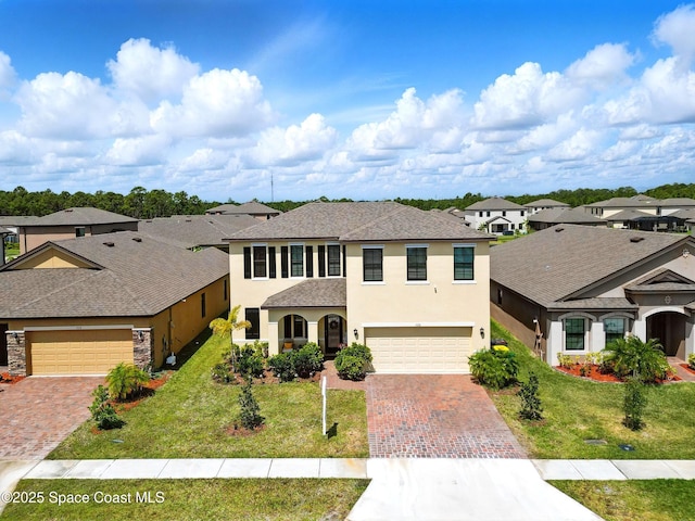 view of front of property with roof with shingles, a residential view, stucco siding, a front yard, and decorative driveway
