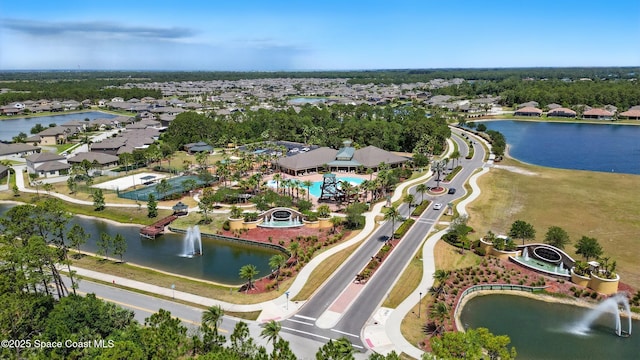 drone / aerial view with a water view and a residential view