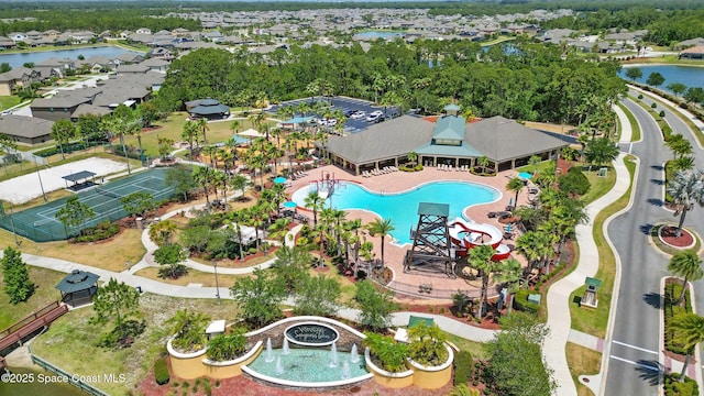 birds eye view of property with a water view and a residential view