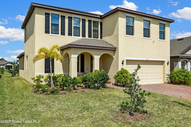 view of front of house with a front lawn, stucco siding, decorative driveway, and a garage