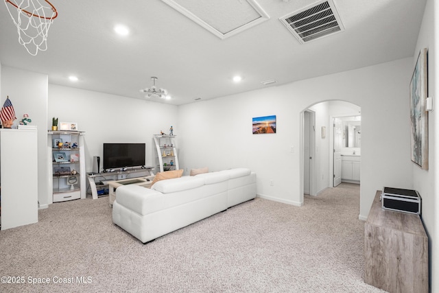 living room featuring carpet, visible vents, arched walkways, and recessed lighting