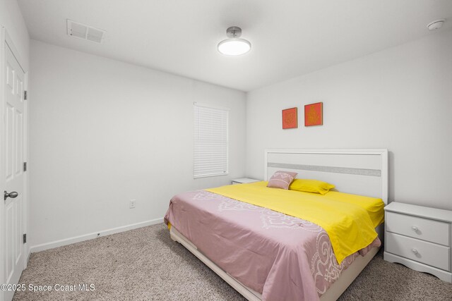 carpeted bedroom with visible vents and baseboards